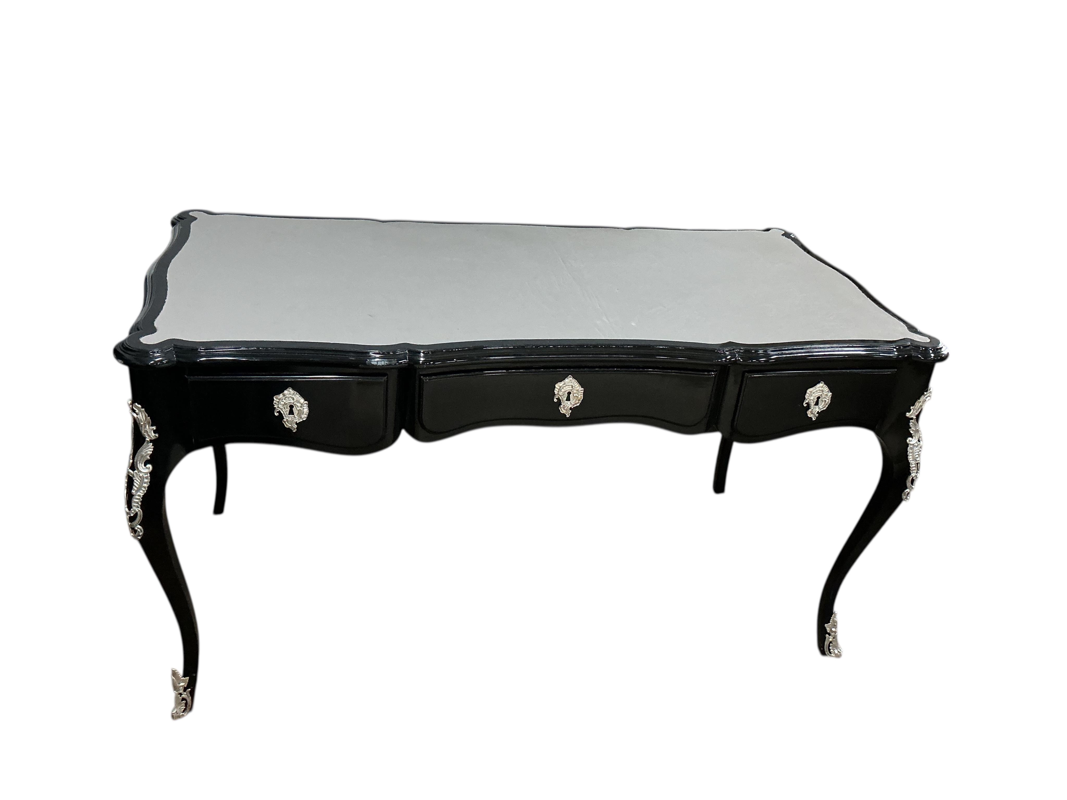 A Contemporary Louis XVI style ebonised bureau plat, width 146cm, depth 71cm, height 79cm